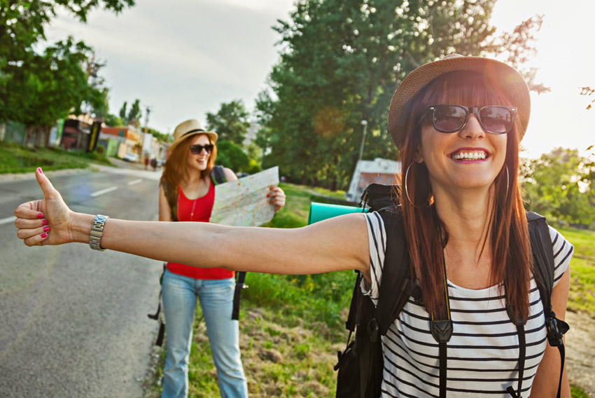 Two Tourist Girl Hitchhiking
